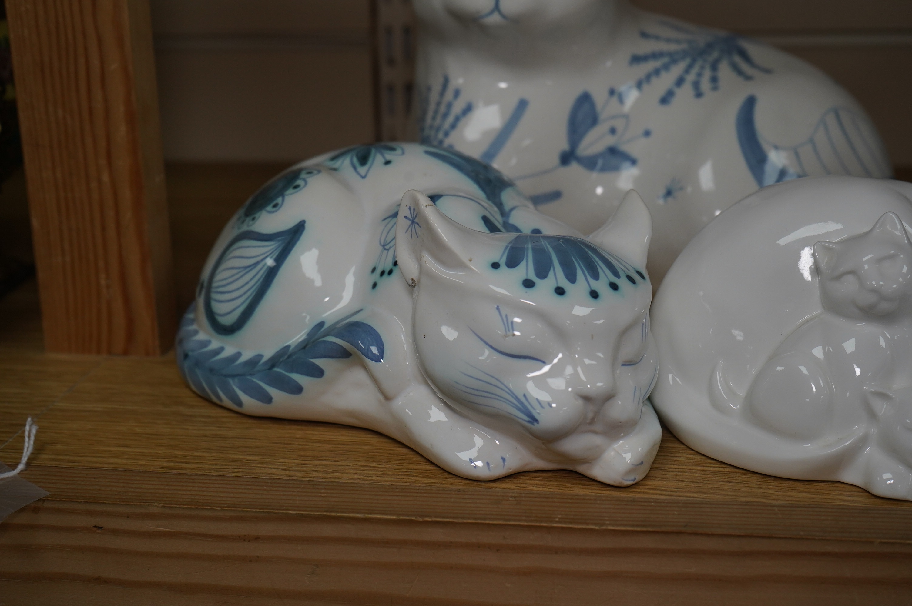 Three large David Sharp Rye pottery models of cats and a Moments by Coalport cat ‘Mothers Love’, tallest 18cm. Condition - largest cat with large firing crack to base otherwise good